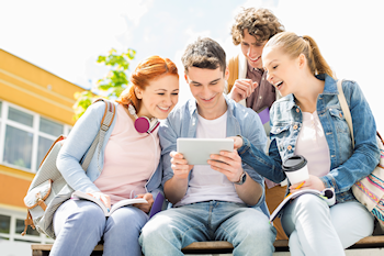 Students laughing at tablet